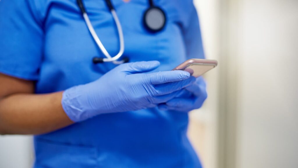 Professionnel de santé utilisant son smartphone personnel en service